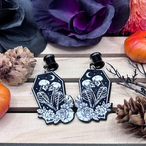 May include: A set of three ceramic mugs with a speckled, matte finish. The mugs are in shades of cream, light brown, and dark brown. Each mug has a simple, minimalist design and a rounded handle.