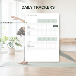 May include: A white habit tracker with the text "Daily Trackers" and "Track Habits Easily". The tracker includes sections for various habits, with a grid for daily tracking. The background features a person doing yoga.