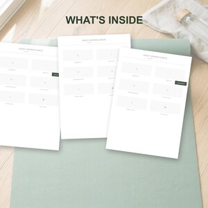 May include: Three white Daily Mindfulness worksheets are displayed on a light green yoga mat. The text "WHAT'S INSIDE" is at the top. A clear glass water bottle with a wooden cap rests on a white cloth.