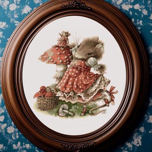 May include: An oval framed print featuring a charming illustration of a mouse in a red polka-dot dress, standing near a mushroom. A basket of mushrooms and a smaller mouse are also depicted. The frame is dark brown.