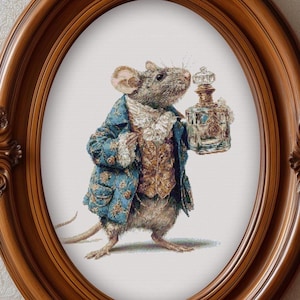 May include: A framed print of a mouse dressed in a blue coat and vest, holding a perfume bottle. The mouse is depicted in a detailed, whimsical style, set within an oval, ornate, brown wooden frame.