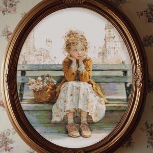 May include: An oval, gold-framed cross-stitch picture shows a girl on a bench with a city background. She wears a yellow coat and floral dress, with a basket of flowers. The artwork is detailed and evokes a nostalgic feel.