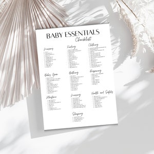 May include: A white paper with the words "BABY ESSENTIALS Checklist" in a stylish font. The checklist is divided into categories like Nursery, Feeding, Clothing, Baby Gear, Bathing, Diapering, Playtime, Nursing, Health and Safety, and Sleeping.