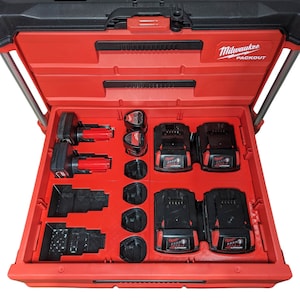 May include: Red Milwaukee Packout tool box with multiple battery compartments. The compartments are filled with black and red batteries. The text "Milwaukee Packout" is printed on the top of the box.