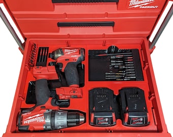 May include: Red Milwaukee Packout tool box with two red and black cordless drills, two black batteries, and a variety of drill bits. The tool box has a black foam insert with cutouts for the tools.