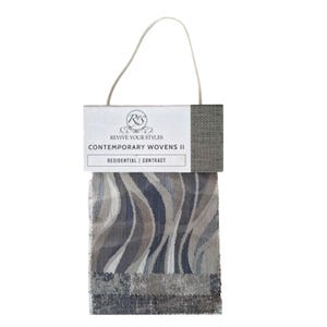 May include: A fabric swatch card featuring samples of Contemporary Wovens II. The card includes a variety of woven fabric samples in shades of gray, blue, and beige. The card is labeled "Revive Your Styles" and "Residential | Contract."