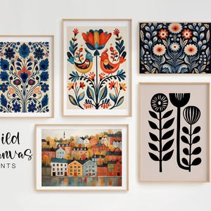 Five framed art prints with floral and landscape designs. The prints feature a variety of colours, including blue, orange, and black. The text "Wild Kanvas PRINTS" is displayed in the lower left corner.