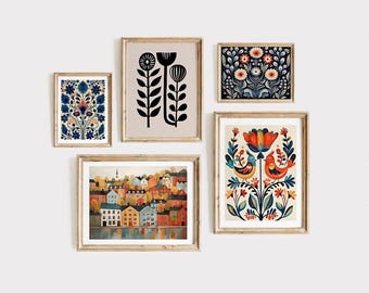 May include: A collection of five framed art prints with a folk art theme. The prints feature floral and landscape designs in various colors, including blue, orange, and black. The frames are a light wood color, and the art is displayed on a white wall.