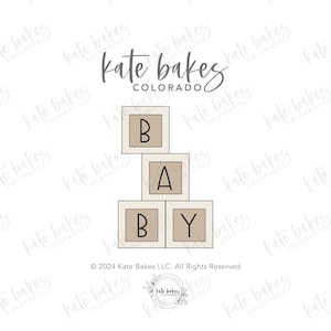 May include: A set of three stacked beige blocks with black outlines, spelling out "BABY". The blocks are on a white background with the text "Kate Bakes Colorado" and a copyright notice.