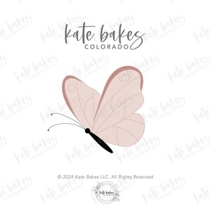 May include: A pink butterfly with black antennae and body, against a white background. The text "Kate Bakes Colorado" is written in cursive above the butterfly.
