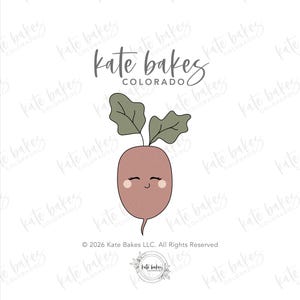 May include: A cartoon illustration of a smiling beet with green leaves. The beet is a light reddish-brown color with a small, curved tail. The text "kate bakes COLORADO" is at the top of the image.