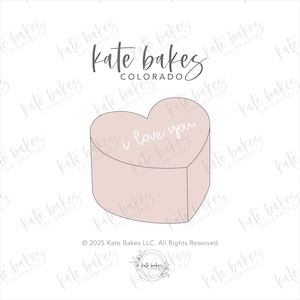 May include: A pink heart-shaped cake with the words "I love you" written on it. The cake is decorated with a simple white outline.