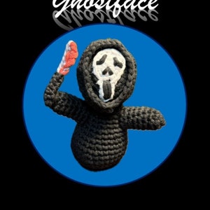 May include: A crocheted Ghostface character from the Scream movie franchise. The character is wearing a black hooded robe with a white mask and holding a red knife. The character is on a blue background with the text "Ghostface" in white above the character.