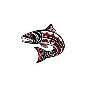 May include: A stylized sticker featuring a salmon design in black, red, and white. The artwork showcases the fish's form with bold lines and intricate patterns, reflecting a Native American art style.
