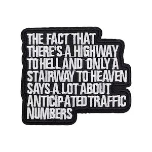 May include: Black and white embroidered patch. The text reads: "THE FACT THAT THERE'S A HIGHWAY TO HELL AND ONLY A STAIRWAY TO HEAVEN SAYS A LOT ABOUT ANTICIPATED TRAFFIC NUMBERS."
