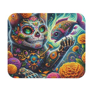 May include: A vibrant, Day of the Dead-themed illustration featuring a cat with a skull face, adorned with colorful floral patterns. The cat's skeletal arm holds a patterned fish. Bright marigold flowers and a swirling background complete the design.