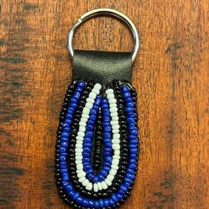 May include: A set of three ceramic mugs with a speckled, matte finish. The mugs are in shades of cream, light gray, and dark gray. Each mug has a simple, minimalist design, perfect for coffee or tea.