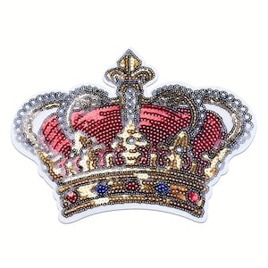 May include: A decorative crown patch with a white border. The crown features red, gold, and silver sequins, with blue and red jewel accents. The design is intricate and detailed, suitable for embellishing apparel or accessories.