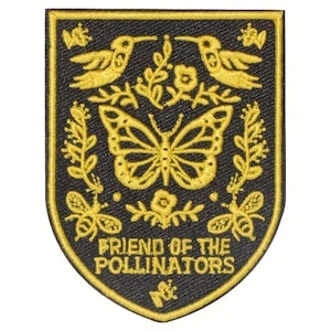 May include: Embroidered patch with a black background and a gold border. The patch features a butterfly, two hummingbirds, bees, and floral elements. The text "FRIEND OF THE POLLINATORS" is displayed at the bottom of the patch.