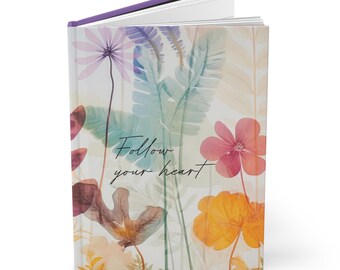Diario cuaderno de tapa dura, femenino y floral, con el lema "Sigue a tu corazón".