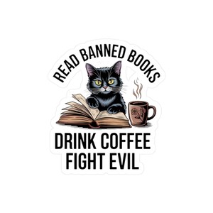 May include: A sticker featuring a black cat reading a book with the text "Read Banned Books, Drink Coffee, Fight Evil." A brown coffee mug with floral design sits next to the cat. The cat has yellow eyes.