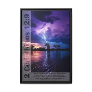 May include: A framed print with a purple and pink sky with a lightning bolt over a lake. The text "2 Corinthians 12:9" is on the left side of the image. The text below the image reads "And he said unto me, My grace is sufficient for thee: for my strength is made perfect in weakness. Most gladly therefore will I rather glory in my infirmities, that the power of Christ may rest upon me."