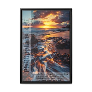 May include: A black framed print with a sunset over the ocean. The water is flowing over rocks and the sky is a mix of orange, pink, and purple. The text "Phillippians 4:6" is on the left side of the image. The text below the image reads "Be careful for nothing; but in every thing by prayer and supplication with thanksgiving let your requests be made known unto God."