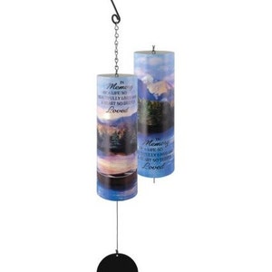 May include: A wind chime with two blue and white cylindrical tubes with a black metal hook and chain. The tubes have a mountain scene and the text "In Memory of a life so beautifully lived and a heart so deeply loved". The chime has a black metal disc at the bottom.
