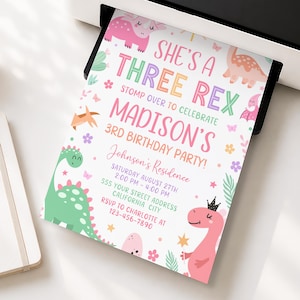May include: A white birthday invitation card featuring colorful illustrations of dinosaurs, flowers, and butterflies. The text reads: SHE'S A THREE REX, STOMP OVER TO CELEBRATE MADISON'S 3RD BIRTHDAY PARTY, Johnson's Residence, SATURDAY AUGUST 27TH, 2:00 PM - 4:00 PM, 555 YOUR STREET ADDRESS, CALIFORNIA CITY, RSVP TO CHARLOTTE AT 123-456-7890.