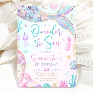 May include: A pink and blue mermaid-themed first birthday party invitation with a mermaid tail, seashells, and the text "Join us Oneder the Sea to celebrate Samantha's 1st Birthday SAT AUG. 23 AT 2:00 PM 555 Your Street Address California City, State RSVP to Amelia Anderson at 123-456-7890"