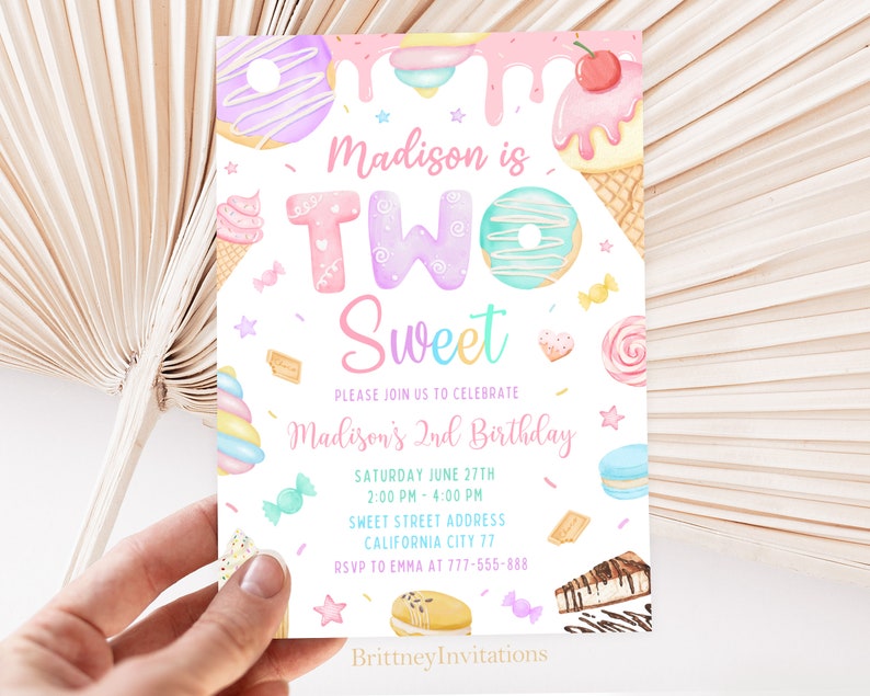 May include: A colorful invitation for a child's second birthday party. The invitation features a sweet theme with a donut, ice cream, and candy. The text on the invitation reads "Madison is Two Sweet" and includes the date, time, and location of the party. RSVP information is also included.