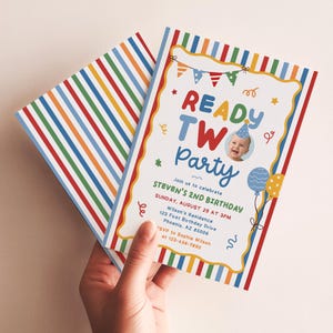 May include: A birthday invitation card featuring a colorful vertical striped border and a white center with the text READY TWO PARTY. It includes a photo of a child in a party hat, bunting, balloons, and event details for Steven's 2nd birthday.