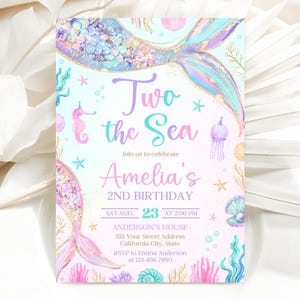 May include: A pink and blue mermaid-themed birthday invitation with a mermaid tail, seashells, and starfish. The text reads "Two the Sea, Join us to celebrate Amelia's 2nd Birthday, Sat Aug. 23 at 2:00 PM, Anderson's House, 555 Your Street Address, California City, State, RSVP to Emma Anderson at 123-456-7890".