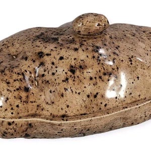 May include: A ceramic potato-shaped serving dish with a lid. The dish is brown with black speckles and has a glossy finish.