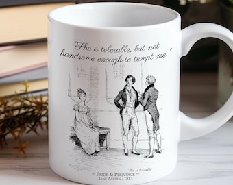 May include: White ceramic mug featuring a black and white illustration from Pride and Prejudice, with a quote from the novel. The mug has a handle and the text "She is tolerable, but not handsome enough to tempt me."