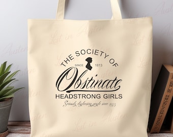 May include: A beige canvas tote bag with black text that reads "The Society of Obstinate Headstrong Girls Since 1813 Seriously disliking people since 1813".