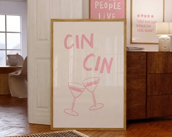 May include: Two pink framed prints with the text "Cool People Live" and "Cin Cin" with a graphic of two martini glasses clinking.