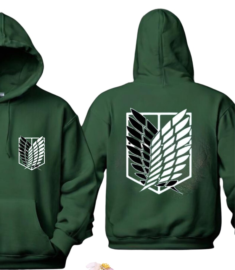 May include: A dark green hooded sweatshirt with a white and black graphic of the Attack on Titan symbol on the back and a smaller version of the symbol on the front.