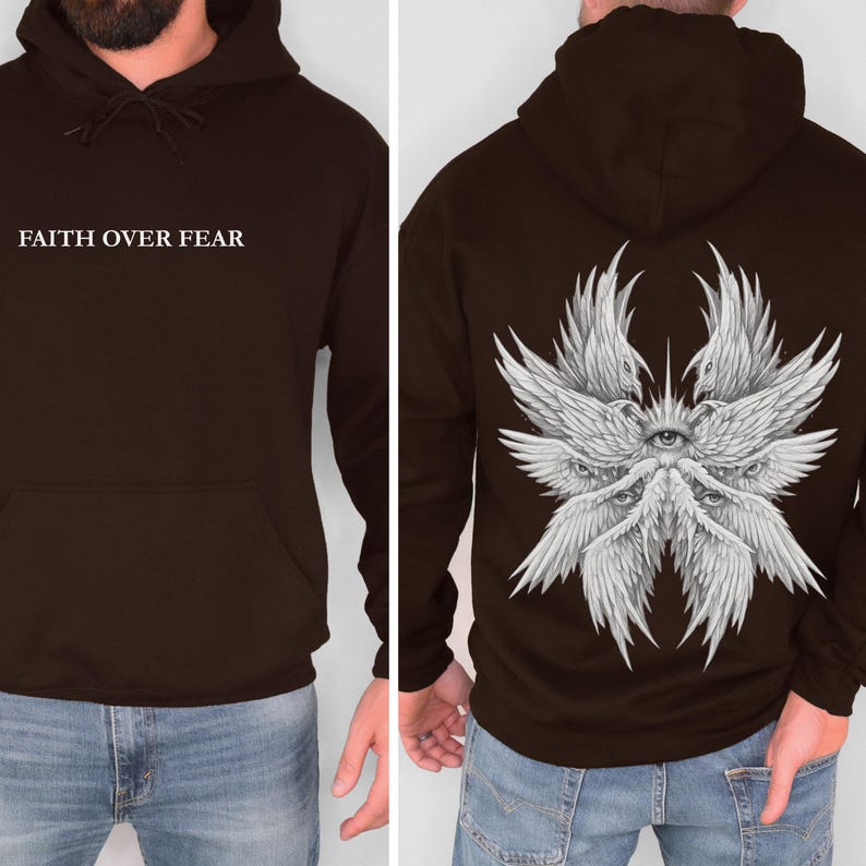 May include: A dark brown hoodie with the text "FAITH OVER FEAR" on the front. The back features a detailed white illustration of multiple wings and eyes. The hoodie has a hood and a front pocket.