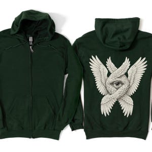 May include: Dark green zip-up hoodie with a front pocket and hood. The back of the hoodie features a detailed white graphic of an eye surrounded by stylized wings. The hoodie is displayed on a white background.
