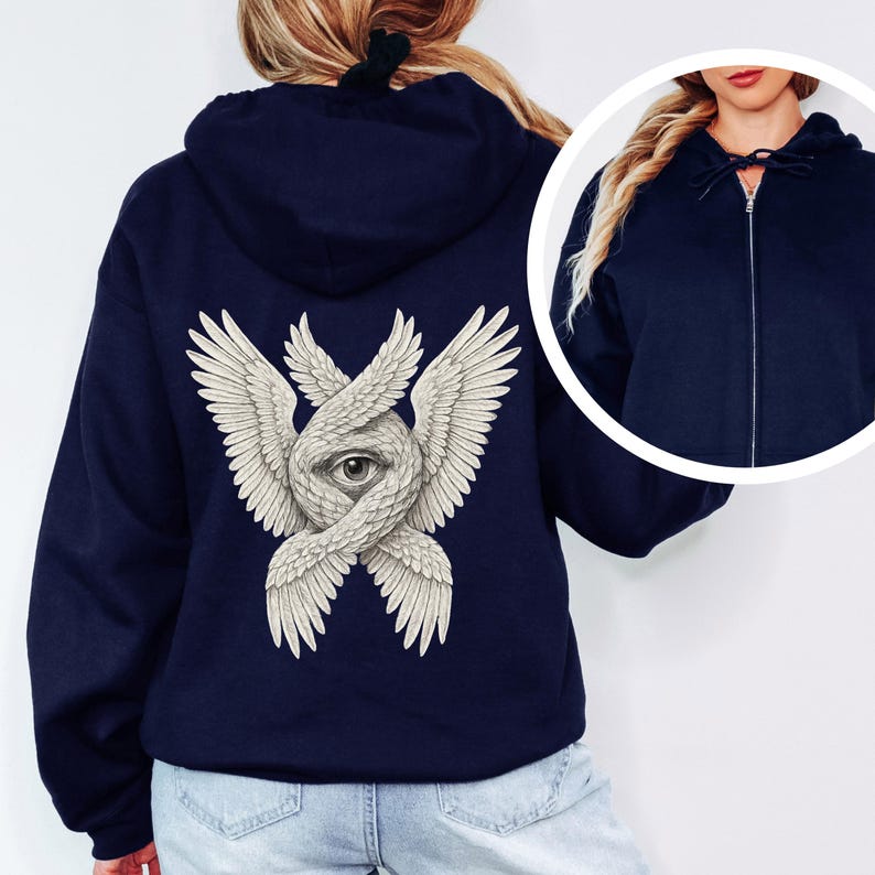 May include: Navy blue zip-up hoodie featuring a detailed graphic on the back. The graphic depicts an eye within intertwined wings, rendered in a detailed, off-white color. The hoodie has a drawstring hood and a full-length zipper.