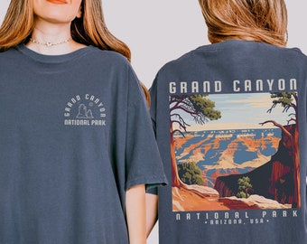 May include: A navy blue t-shirt with a graphic of the Grand Canyon National Park on the back. The front of the shirt has a smaller graphic of the park's logo. The shirt is made of a soft, comfortable material and is perfect for everyday wear.