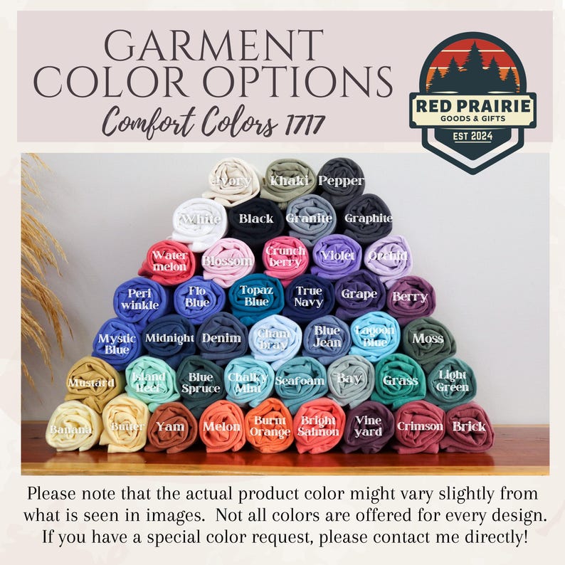 May include: A display of rolled fabric in various colors, including white, black, and blue, with labels identifying each shade. The text "GARMENT COLOR OPTIONS" and "Comfort Colors 1717" are at the top. A logo for Red Prairie Goods & Gifts is in the upper right.