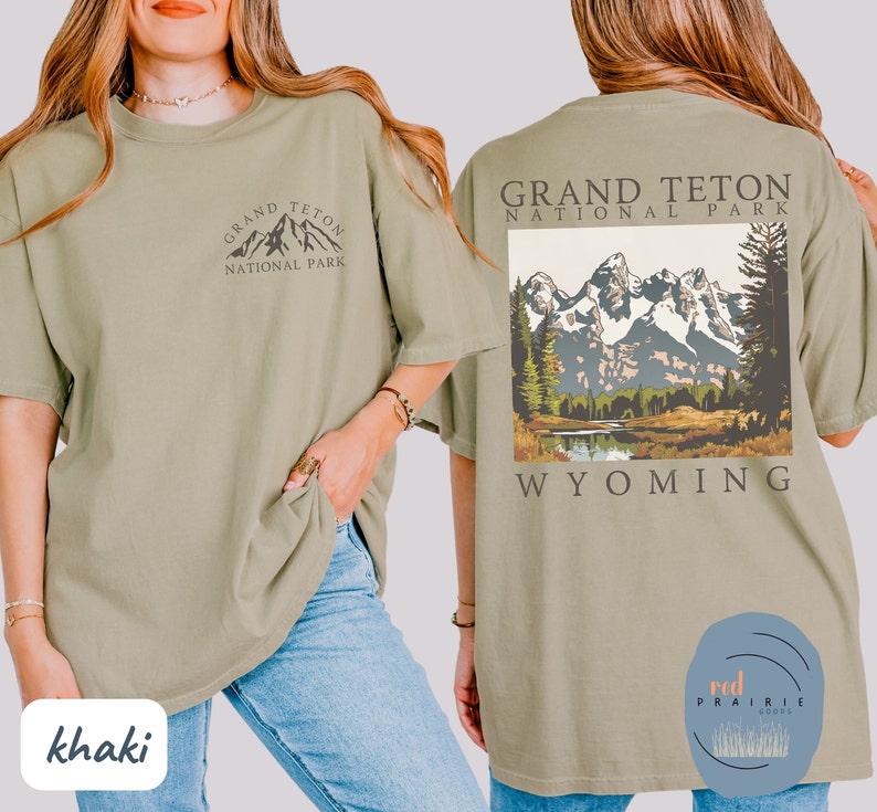 May include: Khaki t-shirt with a graphic of the Grand Teton National Park mountains and the text "Grand Teton National Park Wyoming".