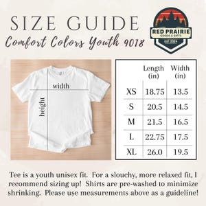 May include: White Comfort Colors youth t-shirt with size guide. Measurements in inches are provided for XS to XL sizes. The Red Prairie Goods & Gifts logo is in the upper right corner. The text "SIZE GUIDE" is at the top.