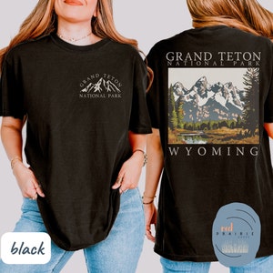 May include: Black t-shirt with a white graphic of the Grand Teton National Park mountains and the text "Grand Teton National Park Wyoming".