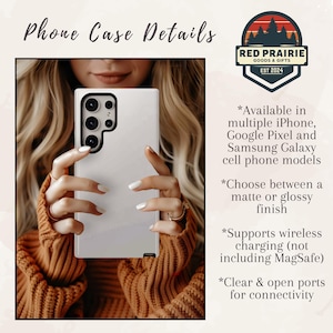 May include: A white phone case with a black camera module is held by a person wearing an orange sweater. The phone case has a matte or glossy finish and supports wireless charging. The image includes the text "Phone Case Details" and the Red Prairie Goods & Gifts logo.