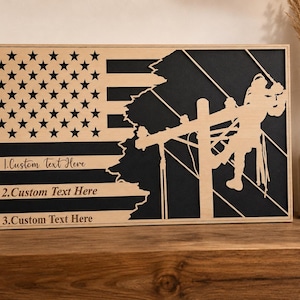 May include: A rectangular wooden wall sign featuring a laser-cut American flag design with a black background. The right side depicts a silhouette of a utility worker on a pole. It includes three lines of text reading 1.Custom Text Here, 2.Custom Text Here, and 3.Custom Text Here.