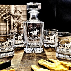 Personalized Lineman whiskey decanter engraved with the Rivera name, displayed with four rocks glasses bearing the standard Lineman emblem.