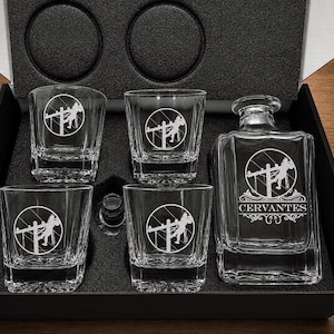Personalized Lineman decanter engraved with the Cervantes name and four standard Lineman-emblem rocks glasses arranged in a black gift box.